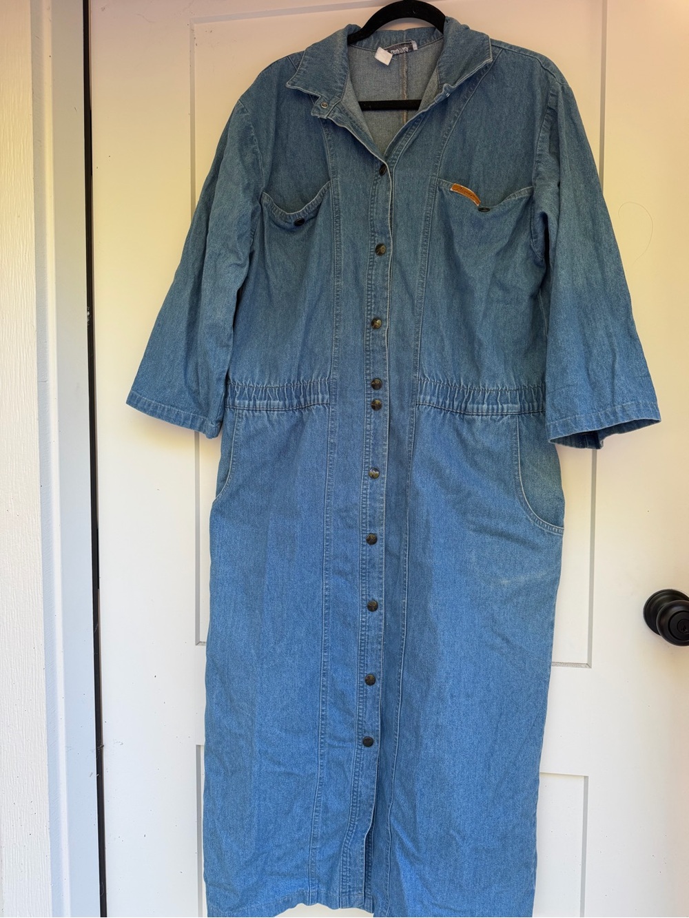 vintage blue denim dress with button-up front, pockets, and elastic waist